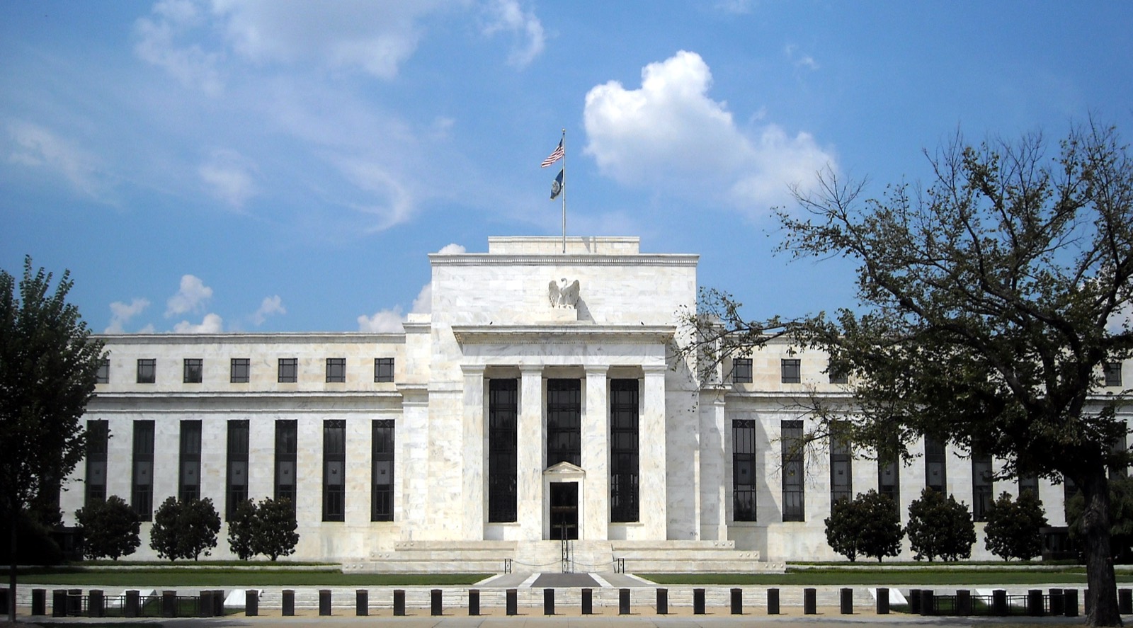 The Marriner S. Eccles Federal Reserve Board Building in Washington, D.C., a white marble neoclassical building with an eagle above the entrance